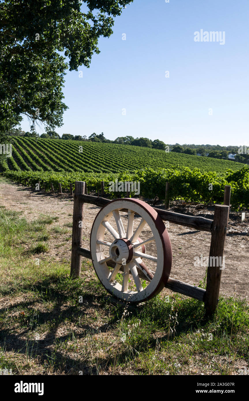 A driveway with a wagon wheel gate leading into a winery in the Barossa ...