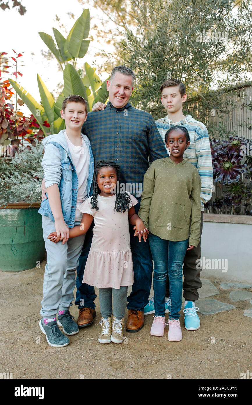 Laughing mixed-race kids with smiling dad Stock Photo - Alamy