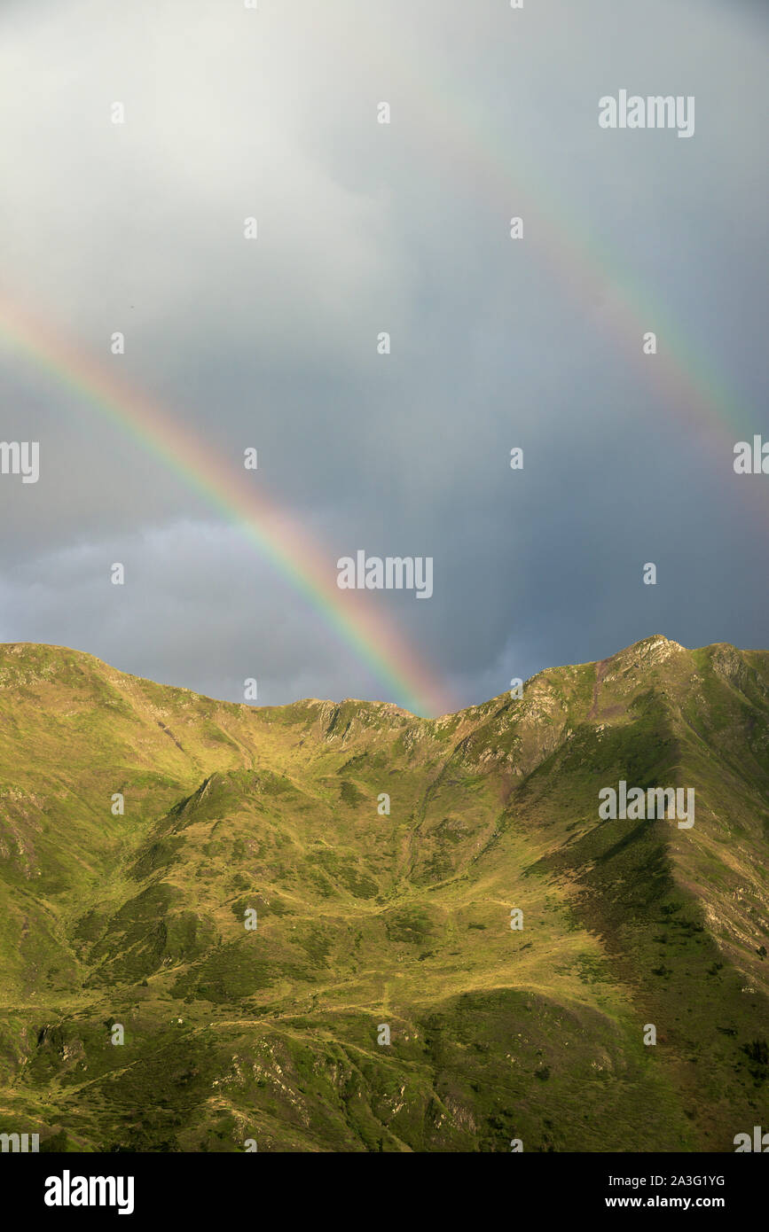 Rainbow during a storm in the Pyrenees. Stock Photo