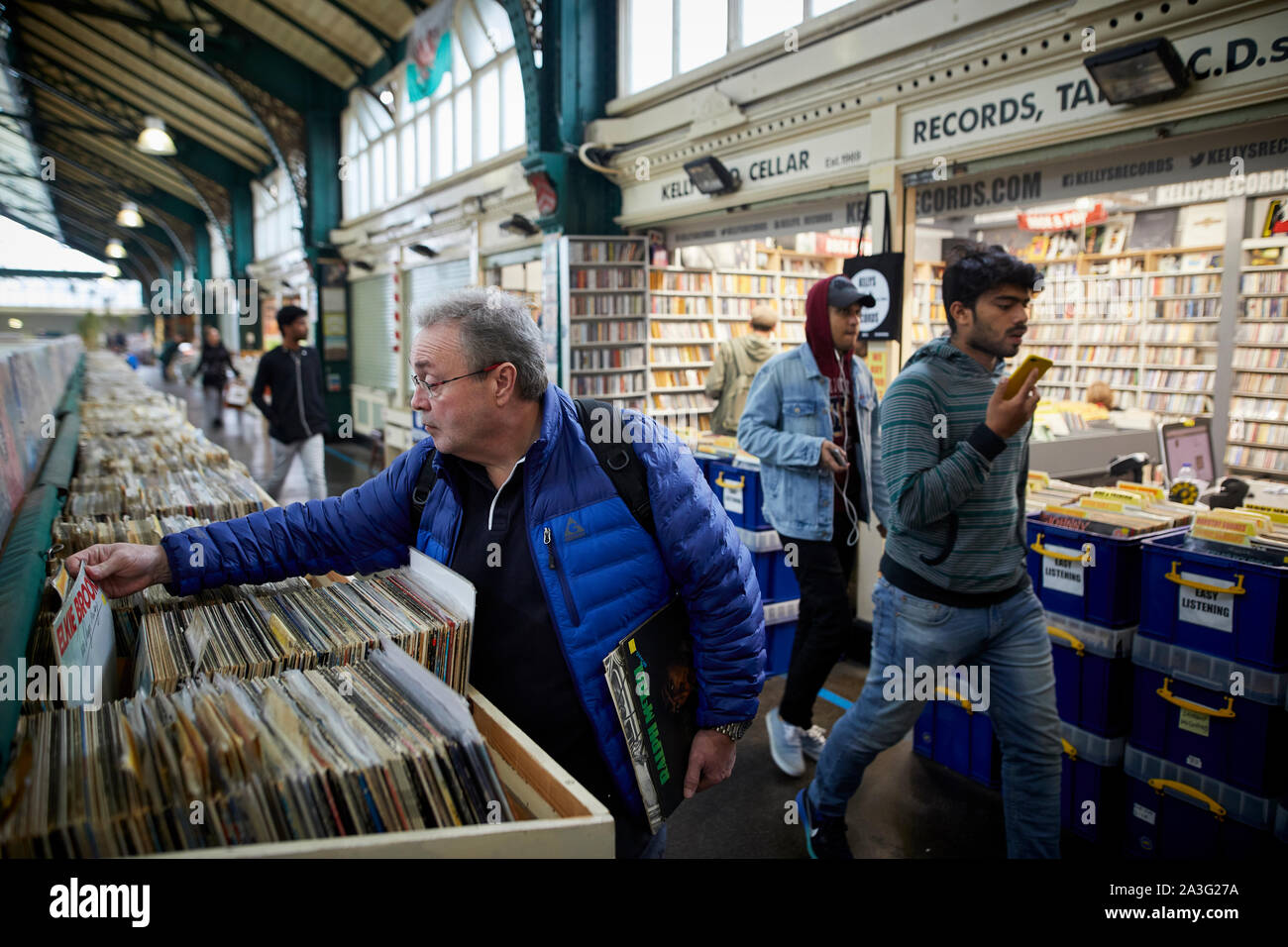 Cardiff Wales, inside the old Central Market hall off  High Street man buying vinyl records at a second hand stall Stock Photo