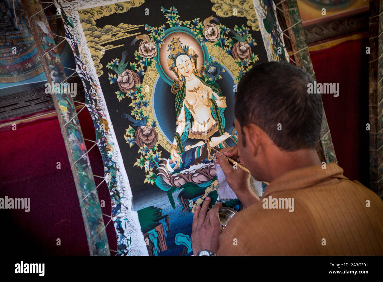 A Nepalese artists finishes a painting in a workshop near Bhaktapur Stock Photo
