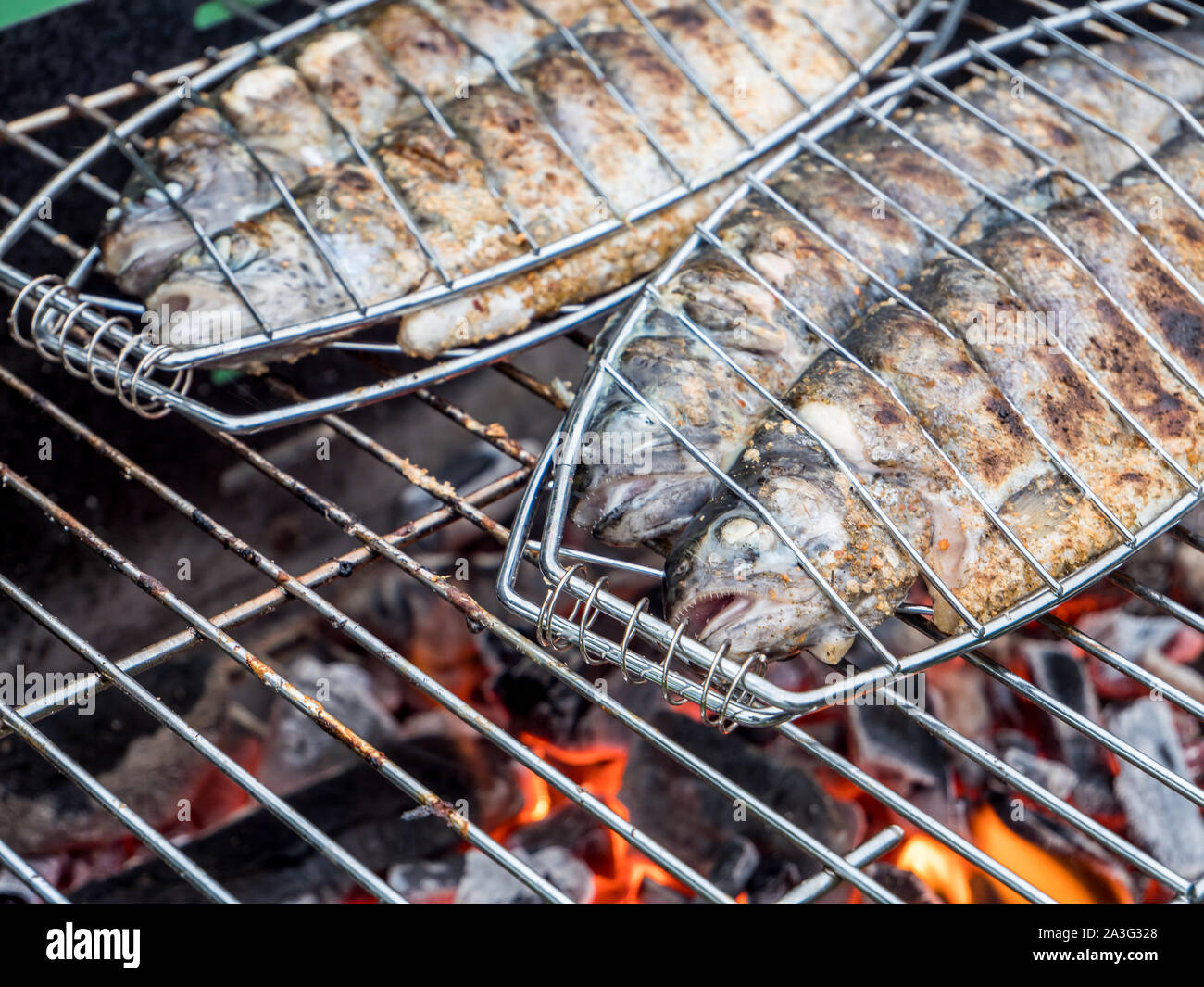 Fish Rosting Fish roasting on the grill in the garden Stock Photo - Alamy