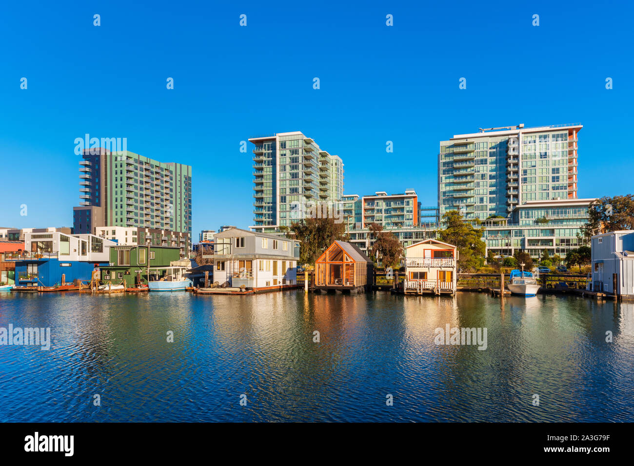 Houseboats on Mission Creek Channel in Mission Bay district in San Francisco, California, USA. Newly developed apartment flats in the background. Stock Photo