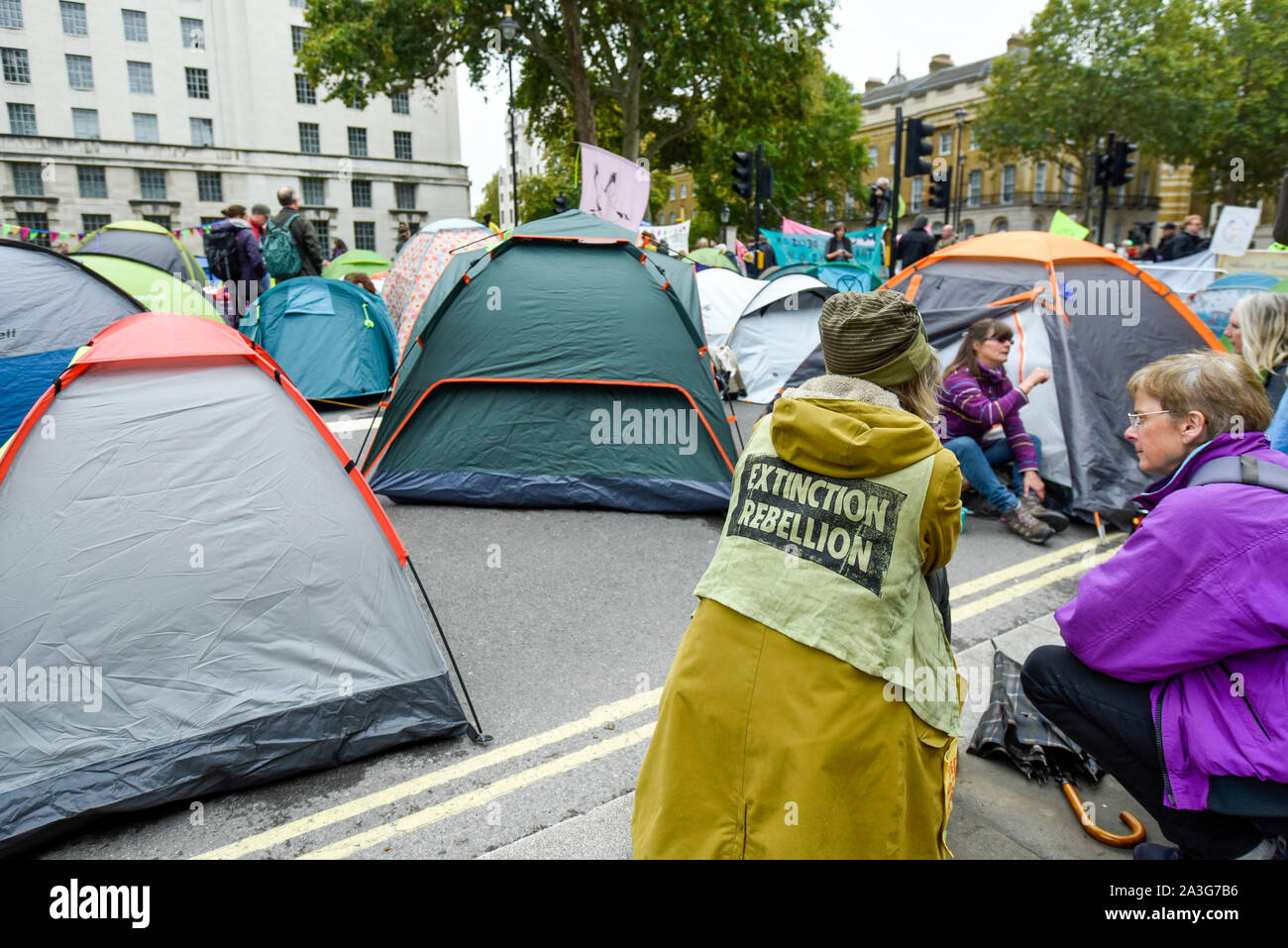 London, UK.  8 October 2019.  Climate activists in a makeshift camp in Whitehall outside Downing Street, on day two of Extinction Rebellion's protest which is planned to close-down Westminster and other areas in the capital for two weeks.  Demonstrators are calling on the Government's immediate action to tackle the negative effects of climate change.  Credit: Stephen Chung / Alamy Live News Stock Photo
