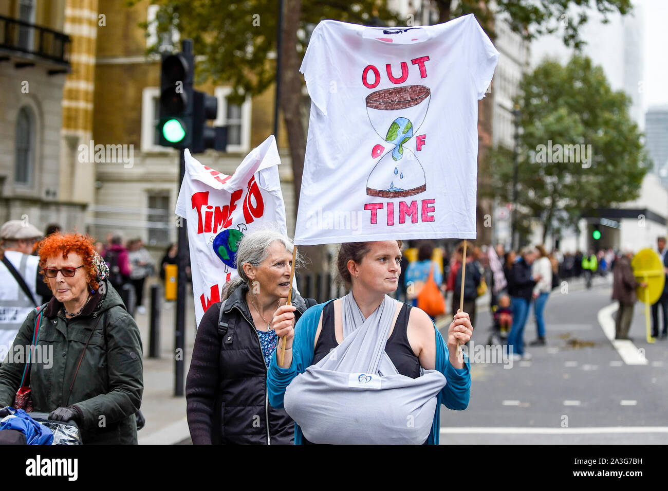 London, UK.  8 October 2019.  Climate activists walk down Whitehall outside Downing Street, on day two of Extinction Rebellion's protest which is planned to close-down Westminster and other areas in the capital for two weeks.  Demonstrators are calling on the Government's immediate action to tackle the negative effects of climate change.  Credit: Stephen Chung / Alamy Live News Stock Photo