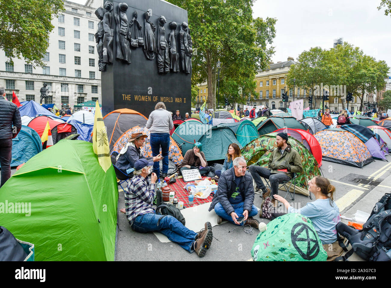 London, UK.  8 October 2019.  Climate activists in a makeshift camp in Whitehall outside Downing Street, on day two of Extinction Rebellion's protest which is planned to close-down Westminster and other areas in the capital for two weeks.  Demonstrators are calling on the Government's immediate action to tackle the negative effects of climate change.  Credit: Stephen Chung / Alamy Live News Stock Photo