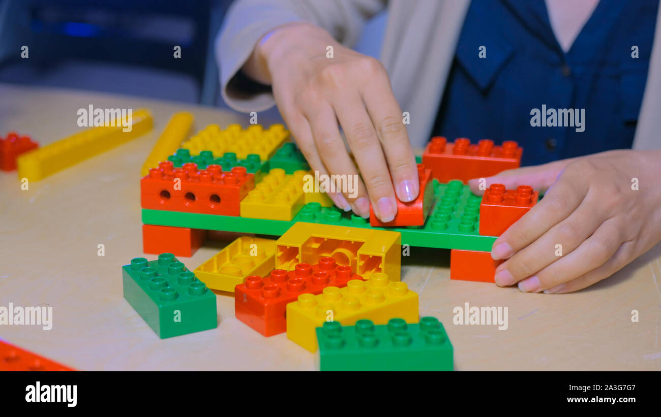 Woman playing with colorful constructor Stock Photo
