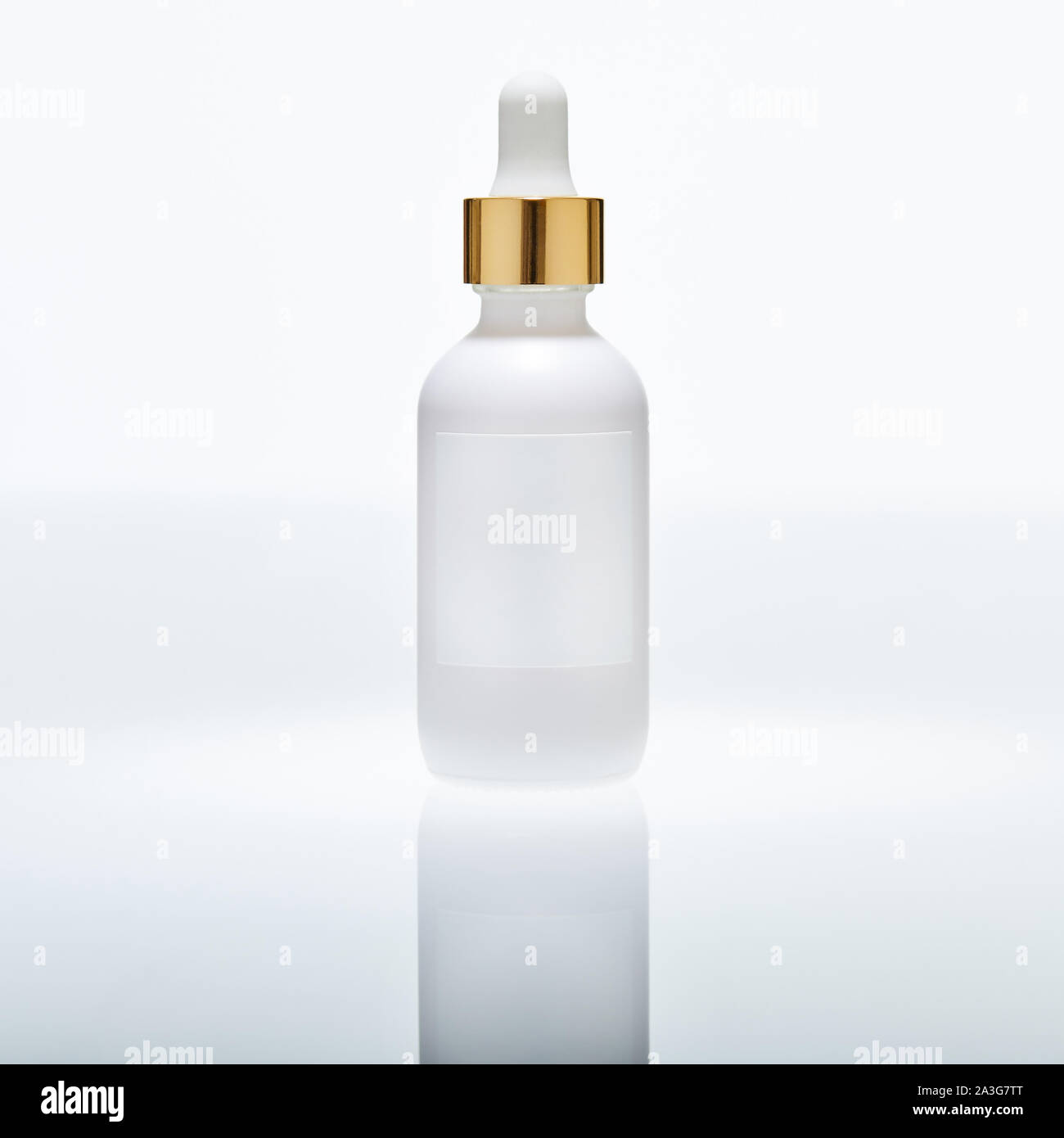 white dropper bottle on white set with reflection Stock Photo