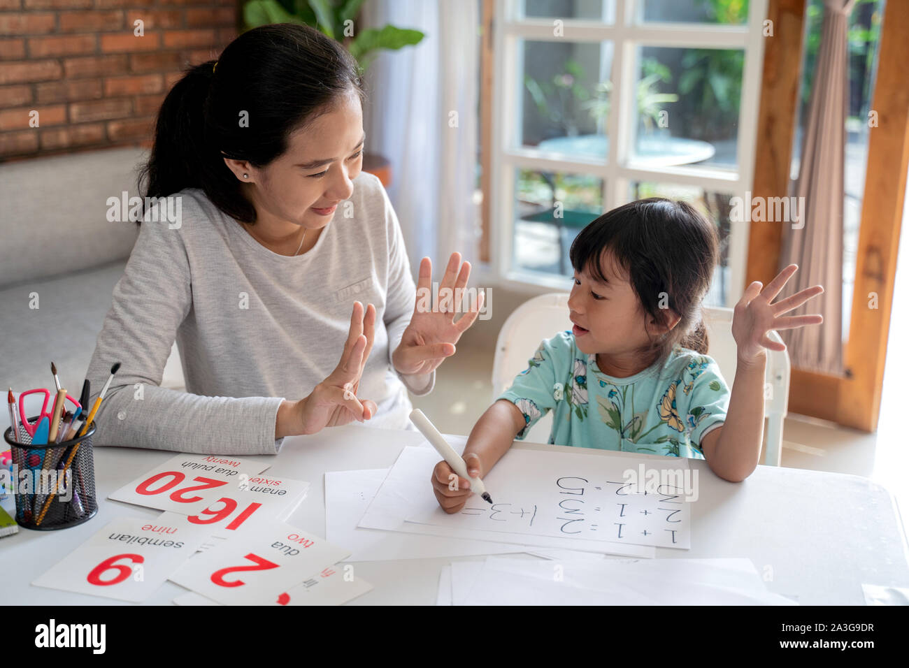 mother teaching basic math to her little daughter at home Stock Photo ...