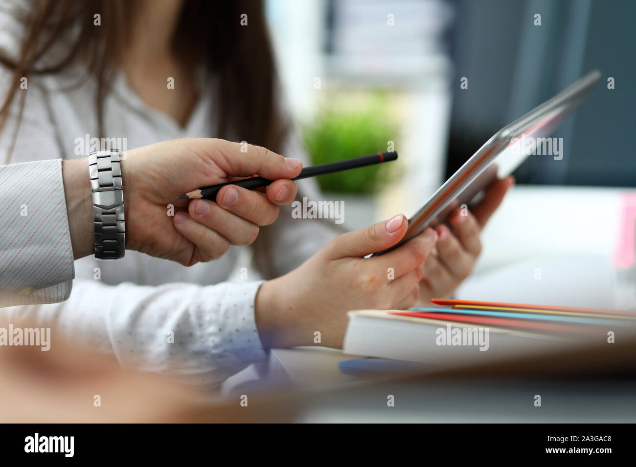 Two architects discussing drawing together using tablet pc Stock Photo