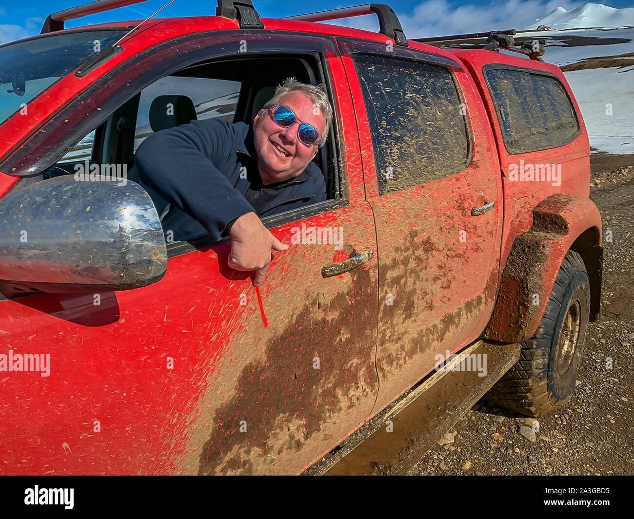 Man in his muddy truck, off road, The Glaciological Society trip, Central Highlands, Iceland Stock Photo