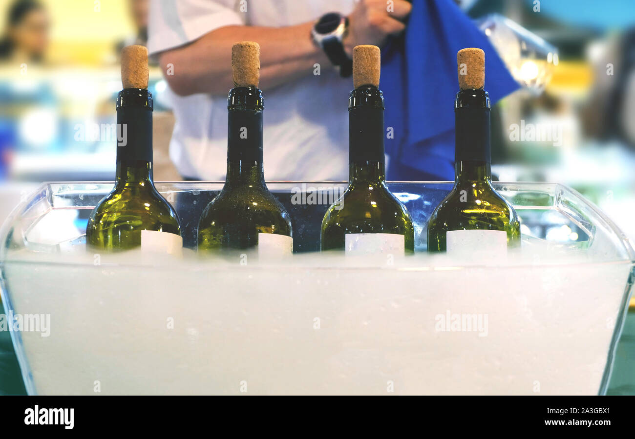 Catering bartender Italian fine wine bottles winetasting session sommelier waiter serving wine people clean glasses background Stock Photo