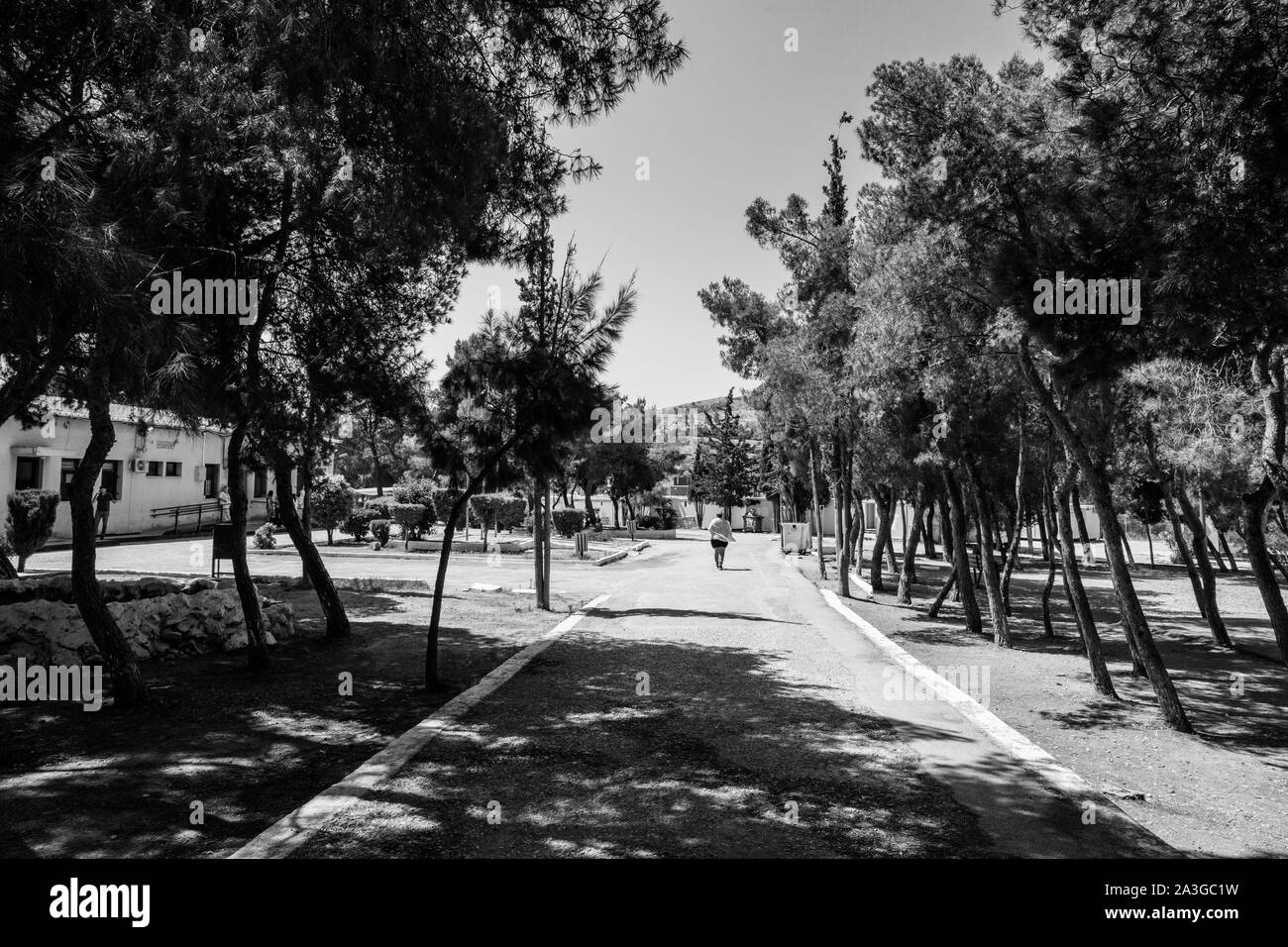 A woman is seen walking down a path in Camp Sxistou.  In 2018, there were almost 66,969 official applications for asylum according to the statistical data published by the Asylum service.  The UNHCR cites 15,670 as the number of refugees who have arrived in 2019. Stock Photo