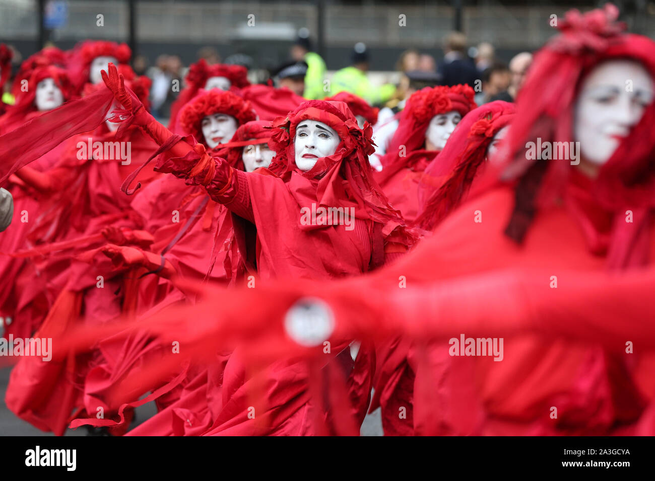Protesters dubbed the Red Rebels at Millbank at the junction with Great College Street, during an Extinction Rebellion (XR) protest in Westminster, London. Stock Photo