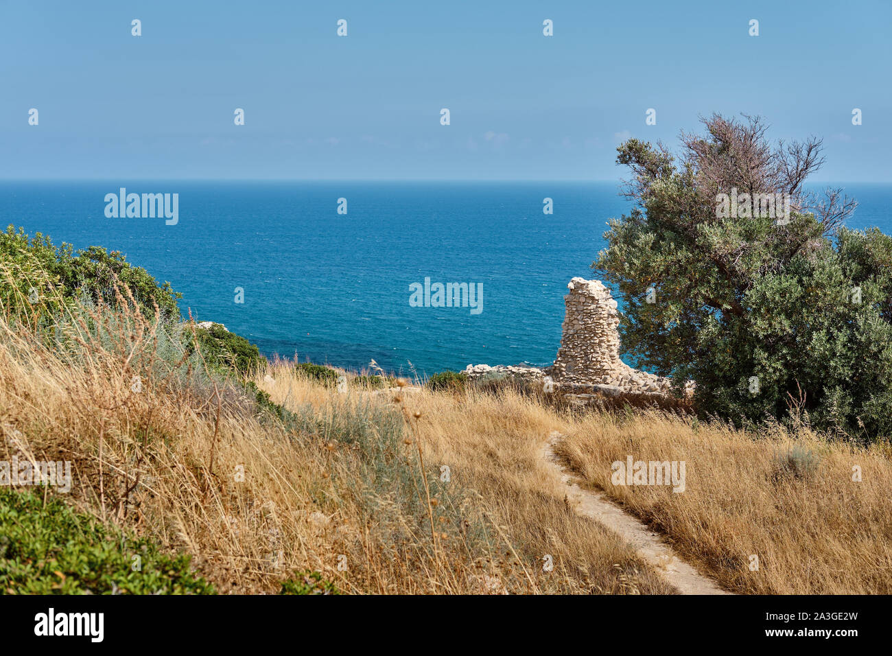 Majestic ruins of the Sanctuary of Apollo Hylates located at the beach of the azure mediterranean sea. Near 3 kilometers west of the Ancient Greek tow Stock Photo