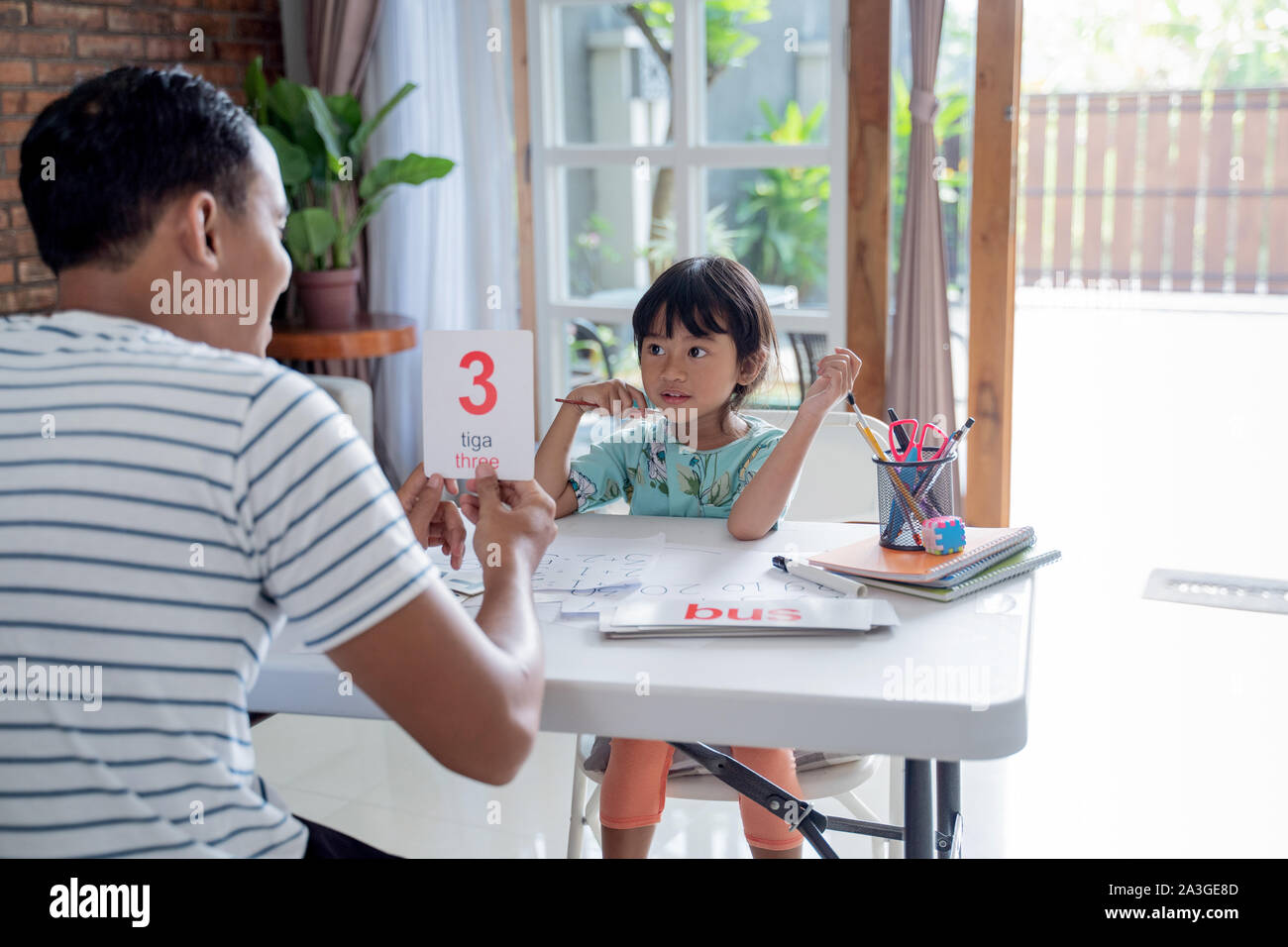 toddler learning simple math using flash card at home with father Stock