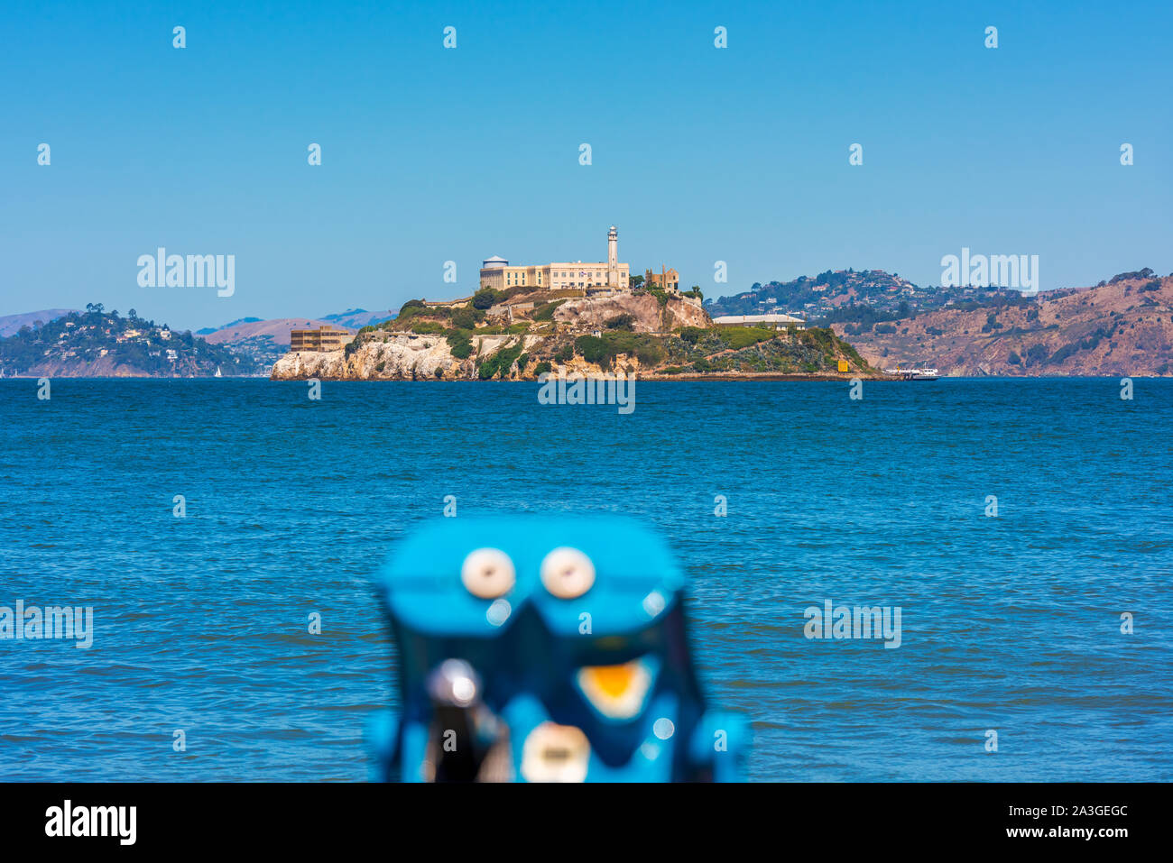 Alcatraz Island and former prison in San Francisco Bay, California, USA. Out of focus binoculars on foreground. Stock Photo