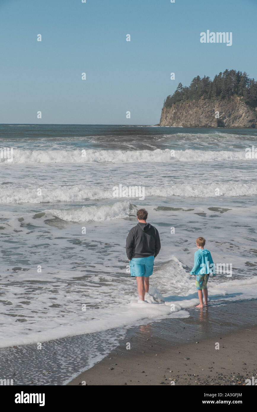 Man and son playing in the ocean Stock Photo