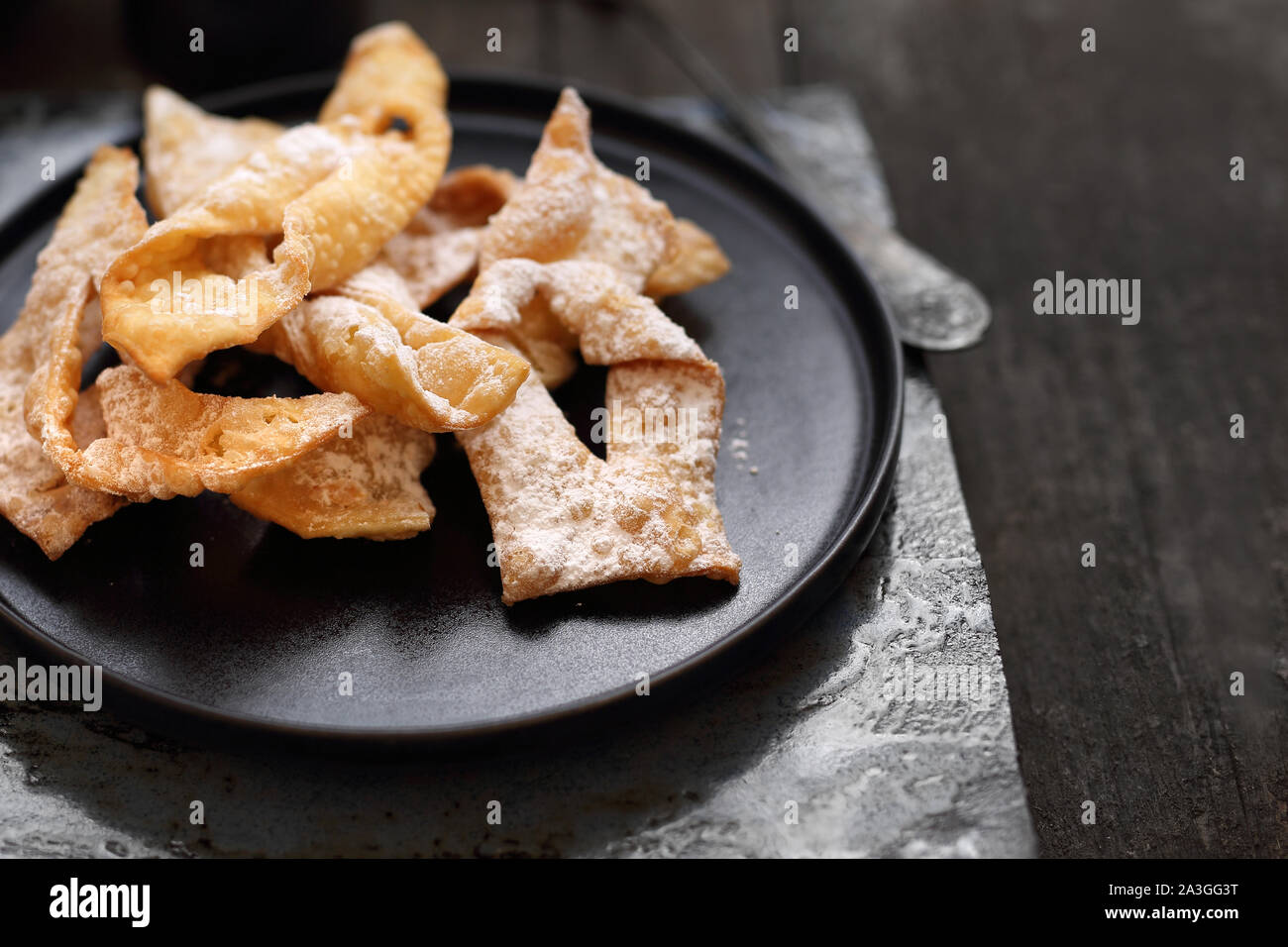 Angel wings.Traditional shortbread crepes with powdered sugar, regional carnival sweets. Stock Photo
