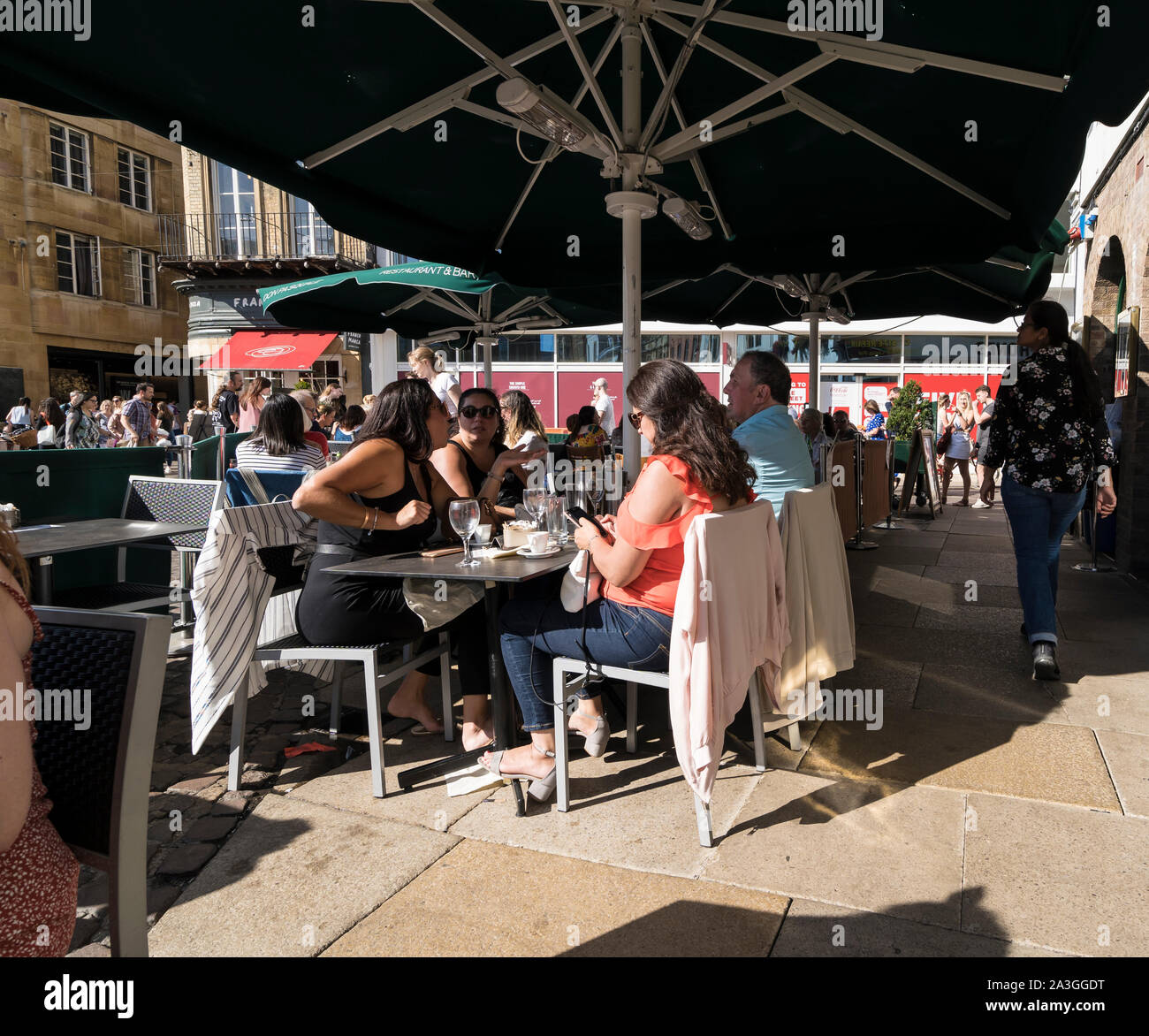 People dining al fresco at City centre restaurant Market Hill Cambridge 2019 Stock Photo