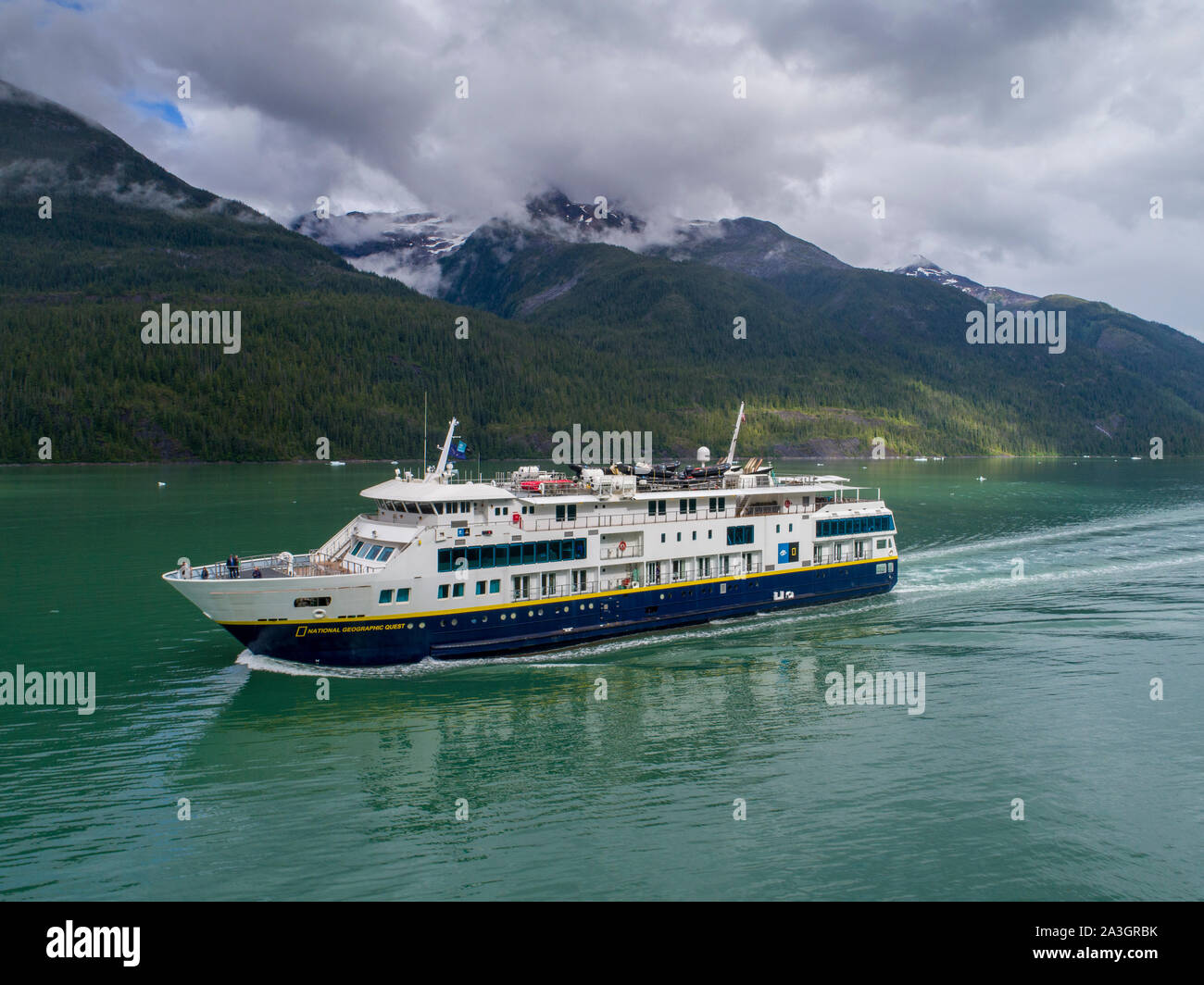 USA, Alaska, Tracy Arm - Fords Terror Wilderness, Aerial view of cruise ship National Geographic Quest motoring in Endicott Arm on summer afternoon Stock Photo