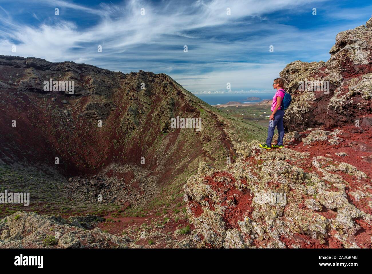 Spain, Canary Islands, Lanzarote Island, Biosphere Reserve, Monte Corona, woman practicing hiking Stock Photo