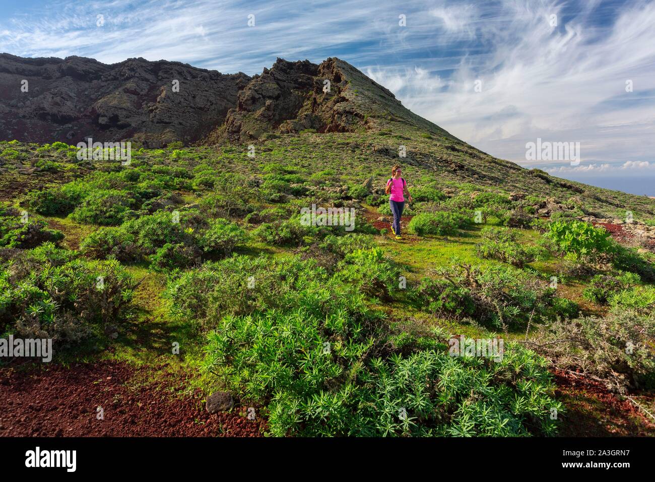 Spain, Canary Islands, Lanzarote Island, Biosphere Reserve, Monte Corona, woman practicing hiking Stock Photo