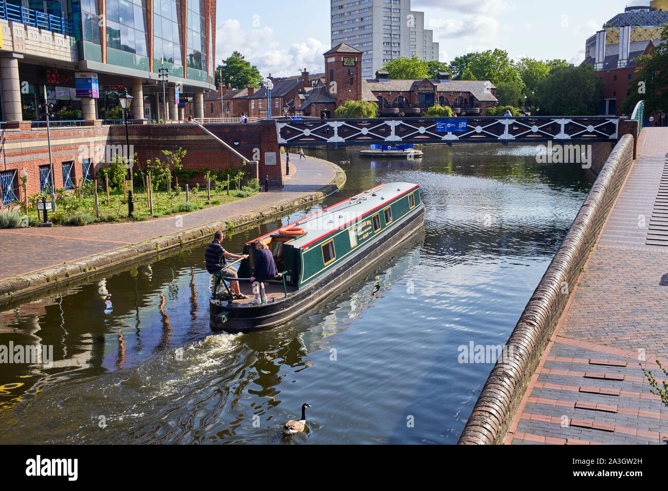A cruiser stern hire boat travelling through the centre of Birmingham near the Gas Street Basin Stock Photo