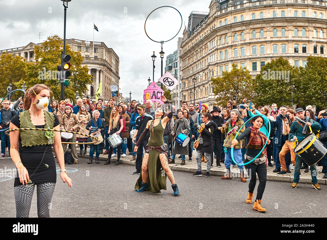 London, U.K. - Oct 8, 2019: Hula-hoop dancers make an impromptu  display on the second day of an occupation of Trafalgar Square by campaigners from Extinction Rebellion. Stock Photo