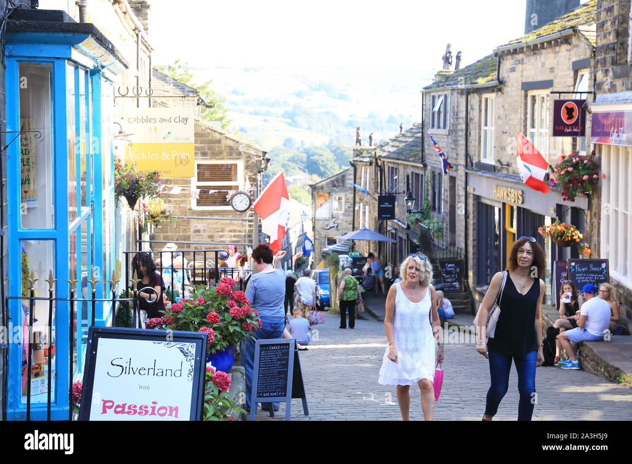 Main Street in the pretty village of Haworth, former home of the Bronte sisters, in West Yorkshire, in England, UK Stock Photo