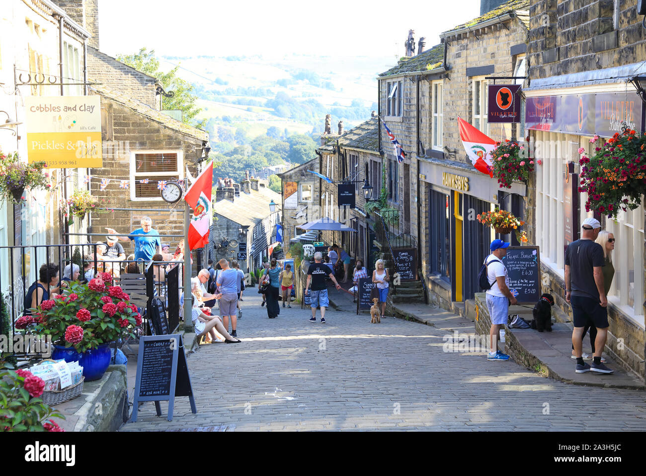 Main Street in the pretty village of Haworth, former home of the Bronte sisters, in West Yorkshire, in England, UK Stock Photo