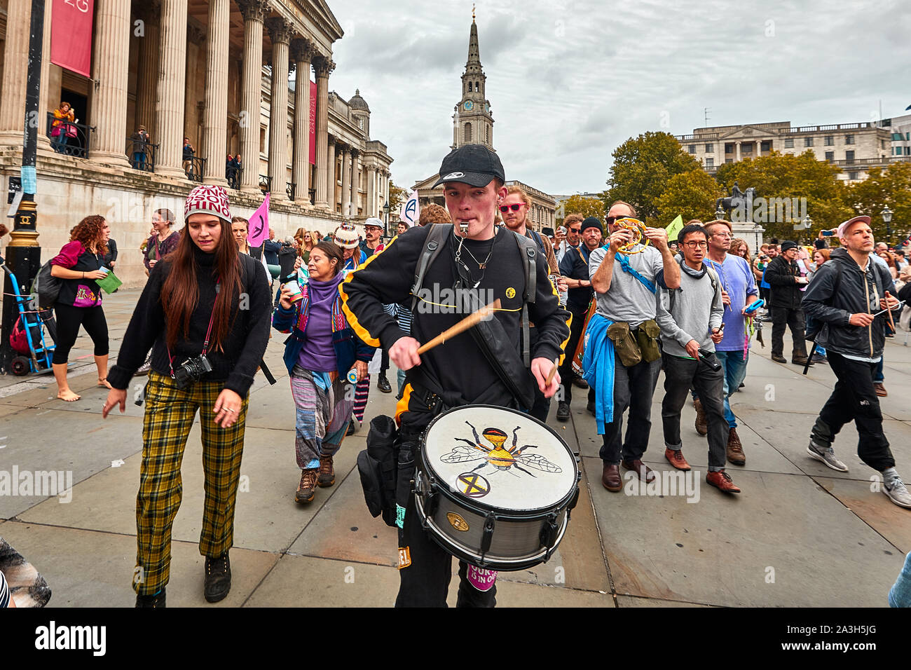 London, U.K. - Oct 8, 2019: A man leads musicians in an impromptu display on the second day of an occupation of Trafalgar Square by campaigners from Extinction Rebellion. Stock Photo