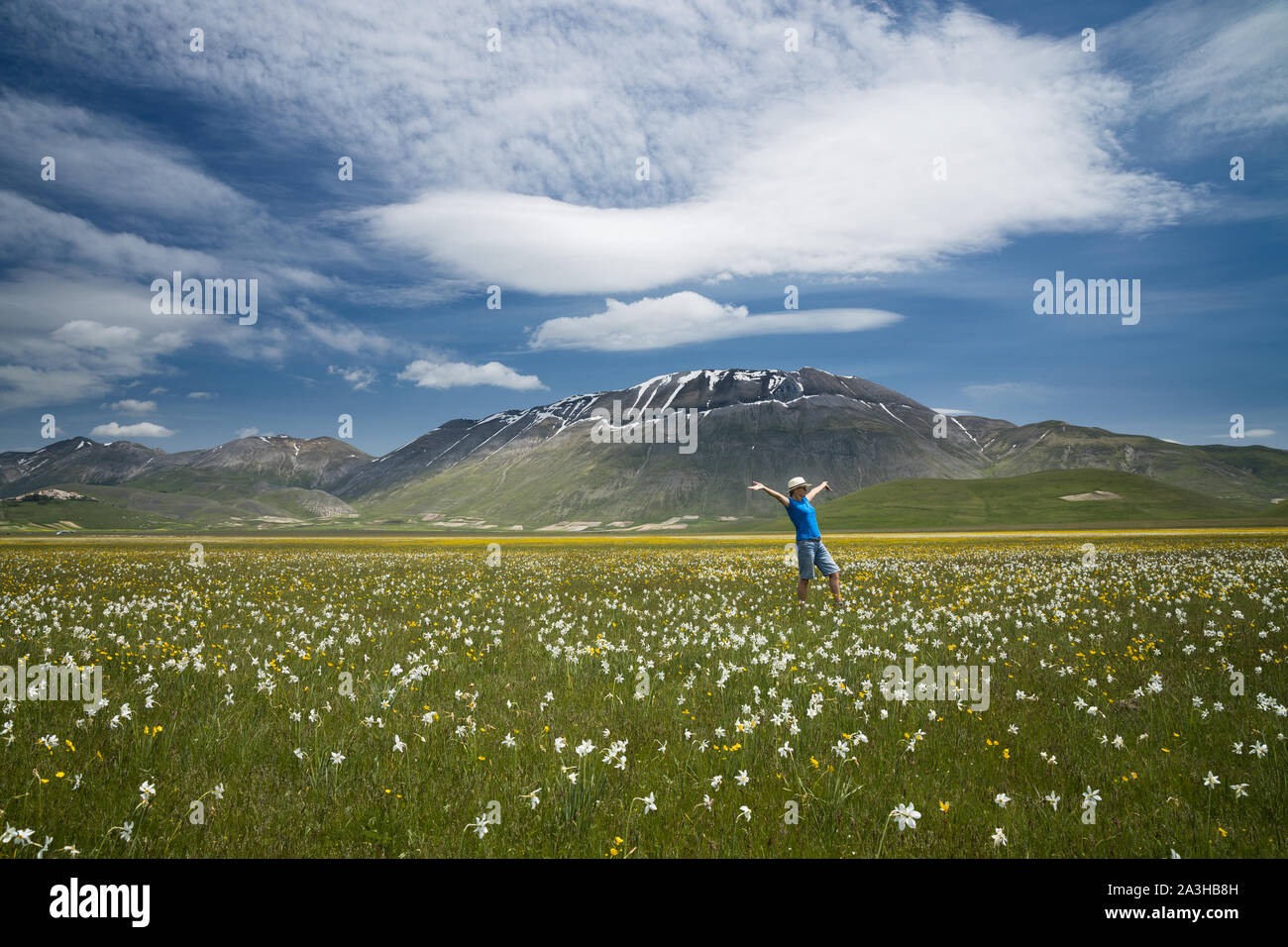 Figure frolicking on the Piano Grande, Monti Sibillini National Park, Umbria, Italy Stock Photo