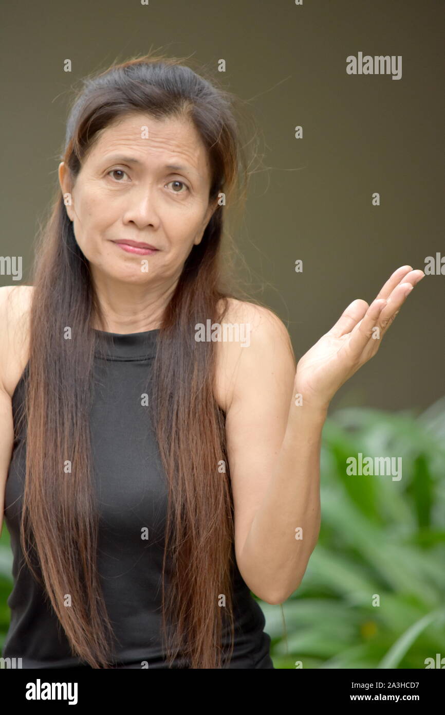 An Undecided Filipina Female Senior Woman Stock Photo - Alamy