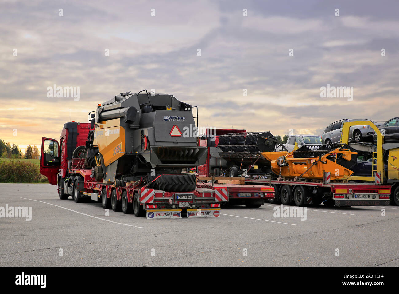 Volvo FH trucks Gois Logistics oversized load transport of Sampo Rosenlew 3085L combine with headers, rear view. Salo, Finland. October 6, 2019. Stock Photo