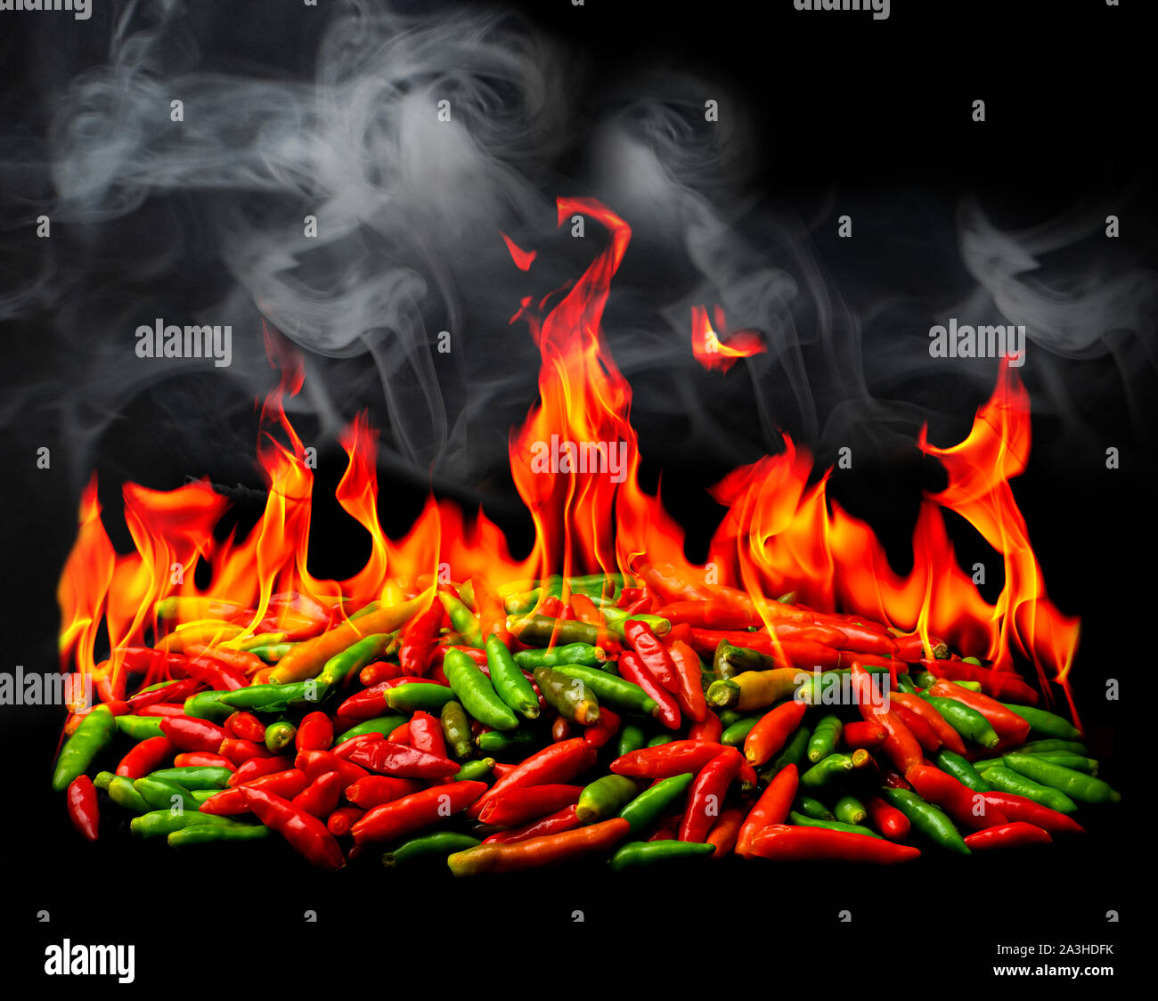 Group of Red Hot chili pepper on fire and smoke at black background Stock  Photo - Alamy