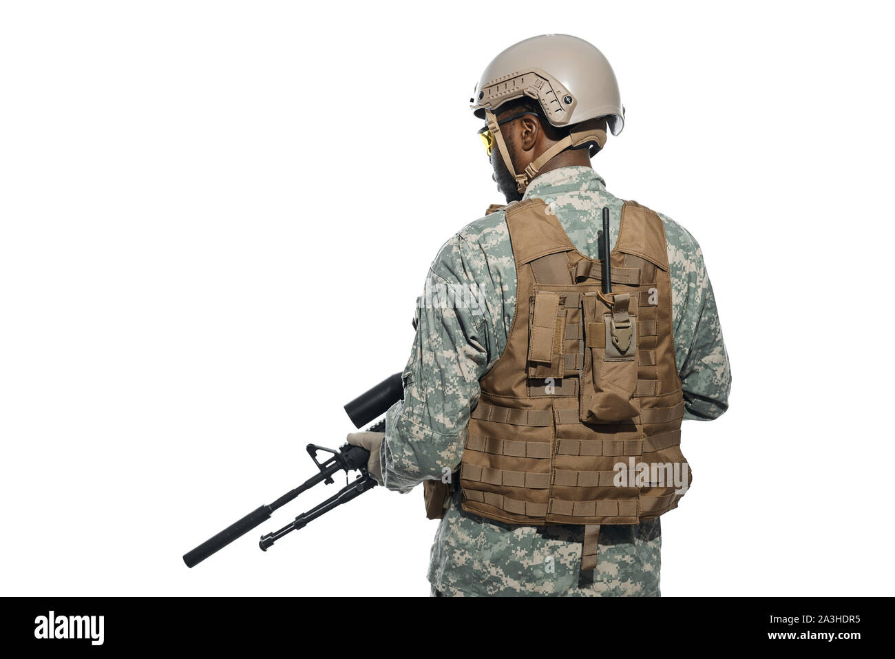 Back view of professional American soldier with modern weapons machine. African male serve in army, wearing helmet, armour and keeping position. Concept of satisfaction of homelands. Stock Photo