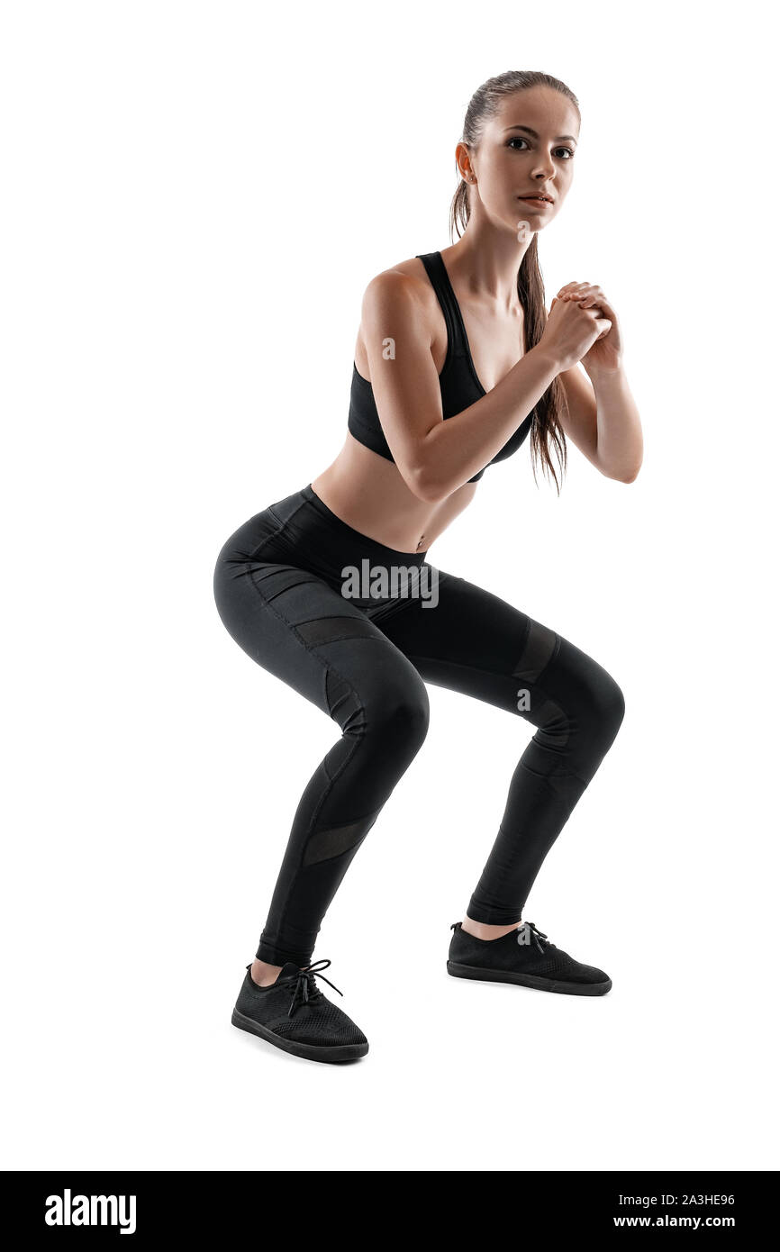Brunette woman in black leggings, top and sneakers is posing isolated on  white. Fitness, gym, healthy lifestyle concept. Full length Stock Photo -  Alamy