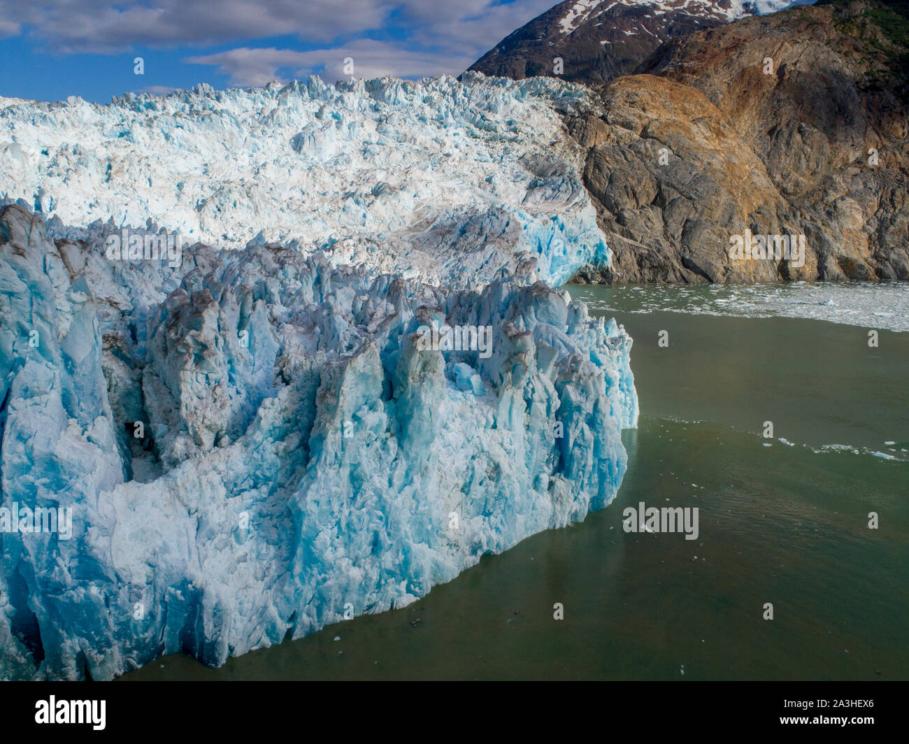 USA, Alaska, Tracy Arm - Fords Terror Wilderness, Aerial view of crevassed blue face of Dawes Glacier on summer afternoon Stock Photo