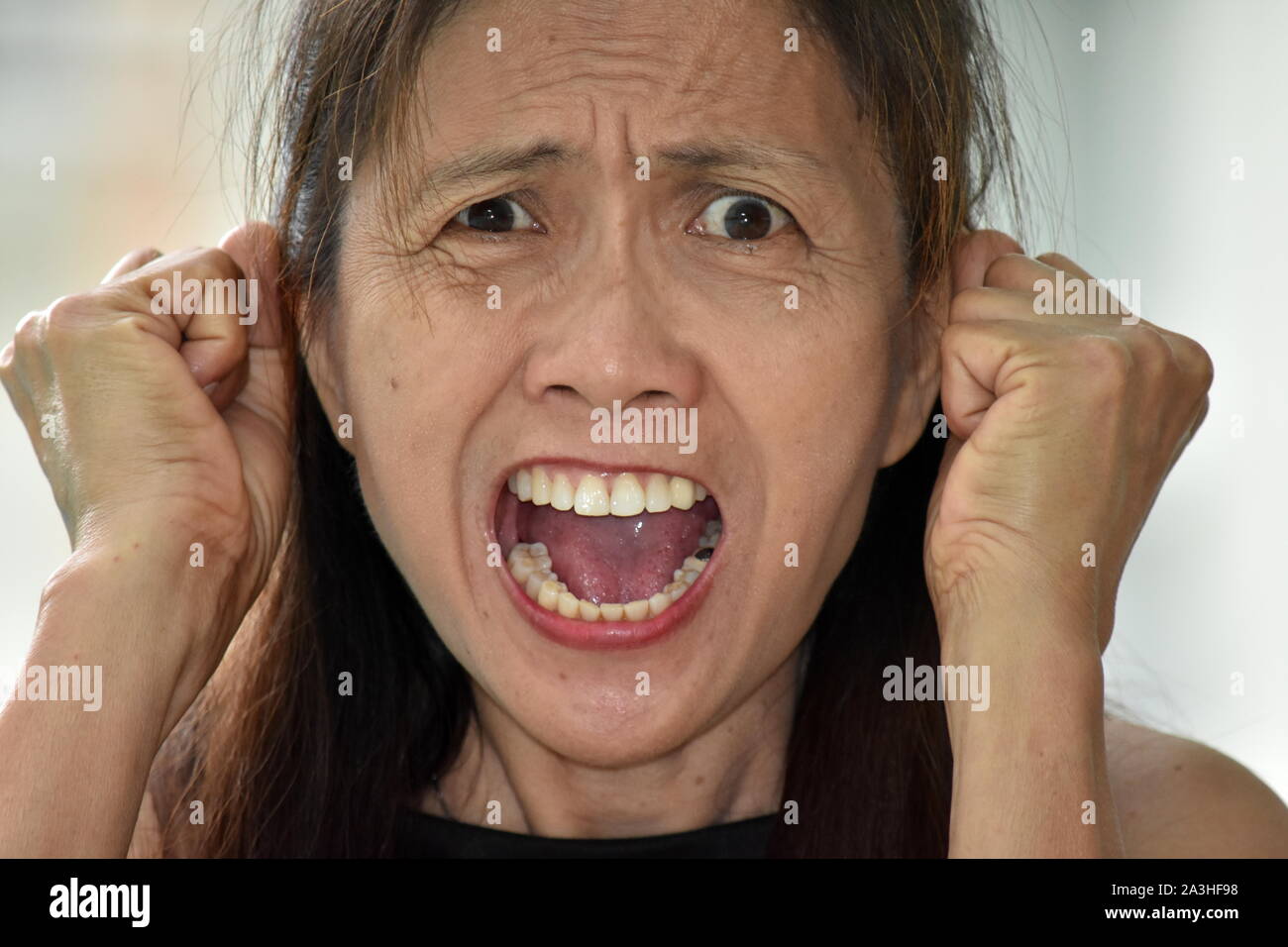 An Older Diverse Woman Shouting Stock Photo