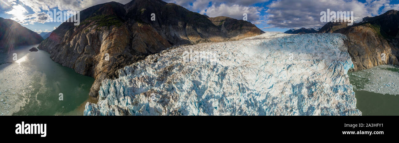 USA, Alaska, Tracy Arm - Fords Terror Wilderness, Panoramic aerial view of crevassed blue ice face of Dawes Glacier in Endicott Arm at sunset on summe Stock Photo