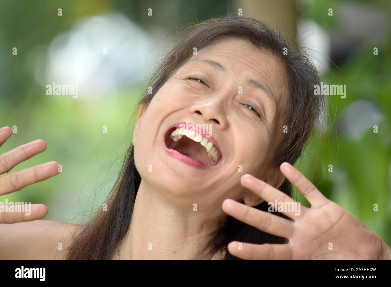 A Laughing Filipina Female Senior Stock Photo
