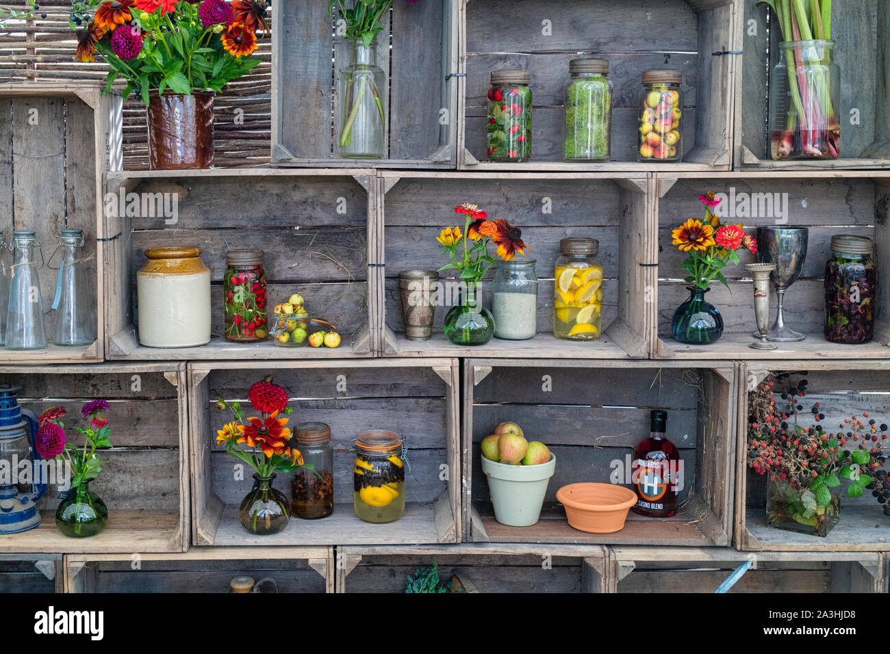 Old fashioned kilner gin jars infused with fruits and nuts with vases ...