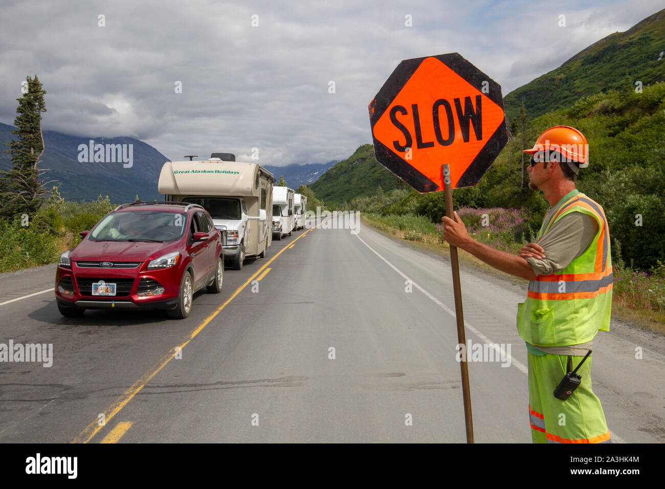 Road construction worker with sign along the Richardson Highway near Valdez Alaska. Stock Photo