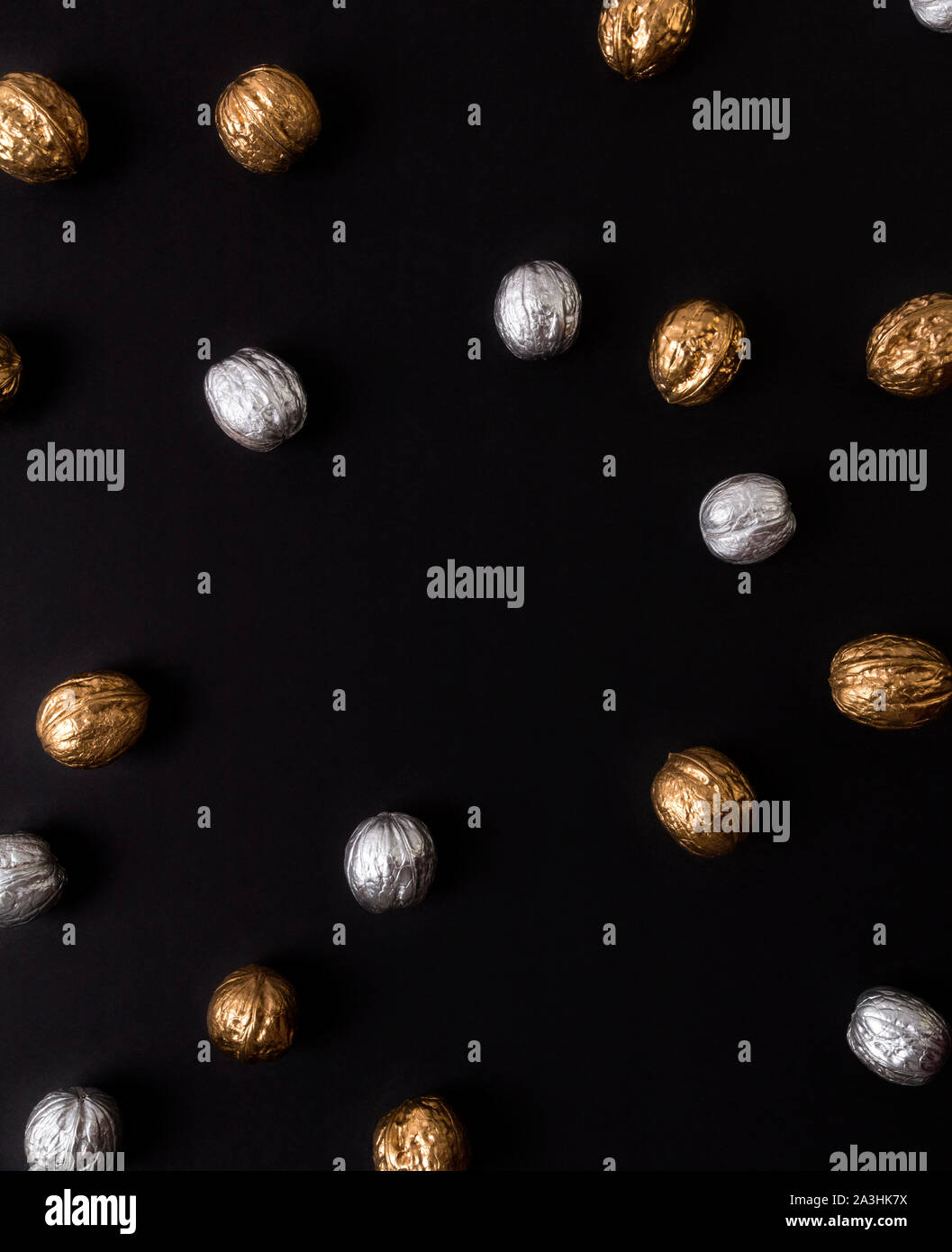Painted golden and silver walnuts on black background Stock Photo