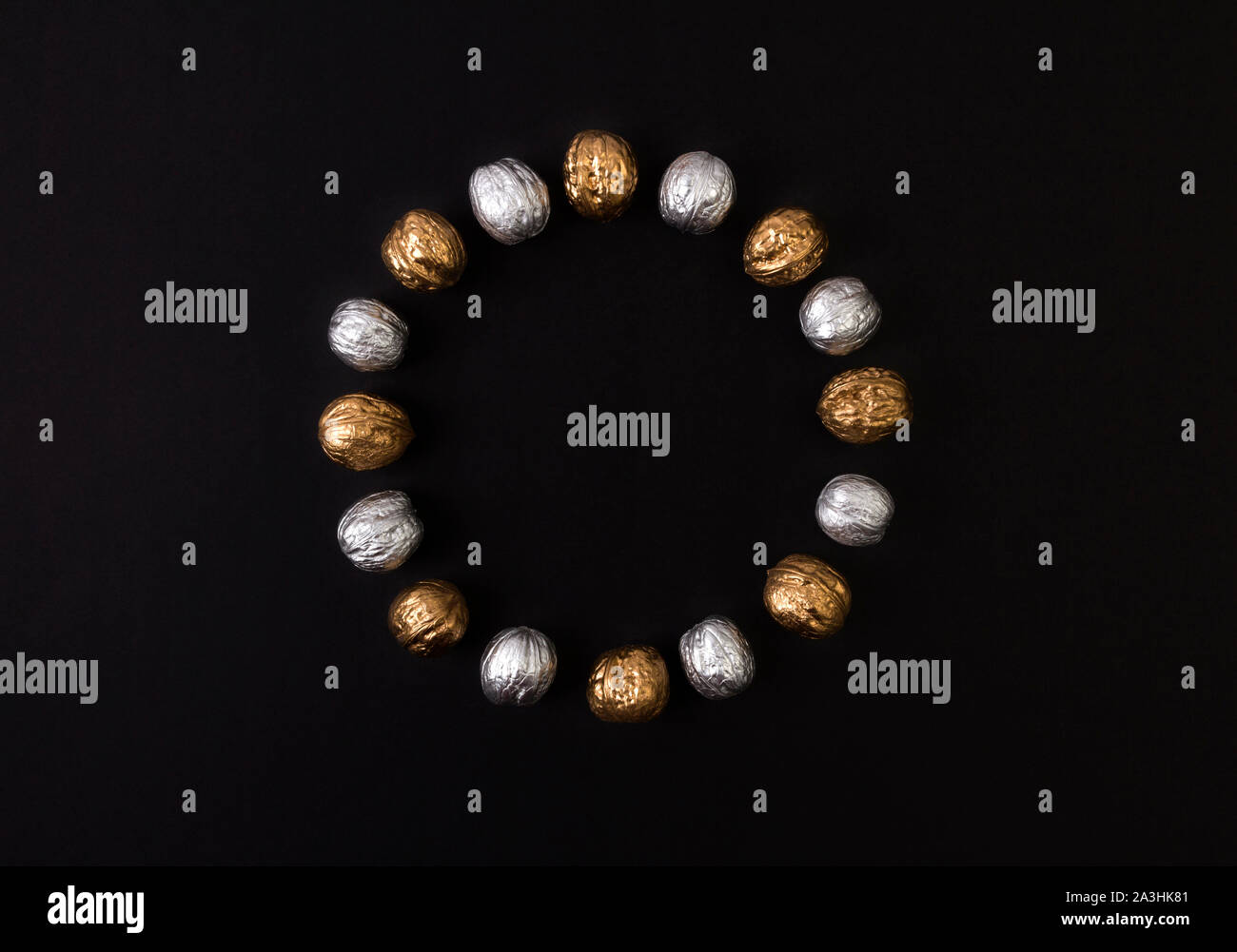 Painted golden and silver walnuts on black background Stock Photo