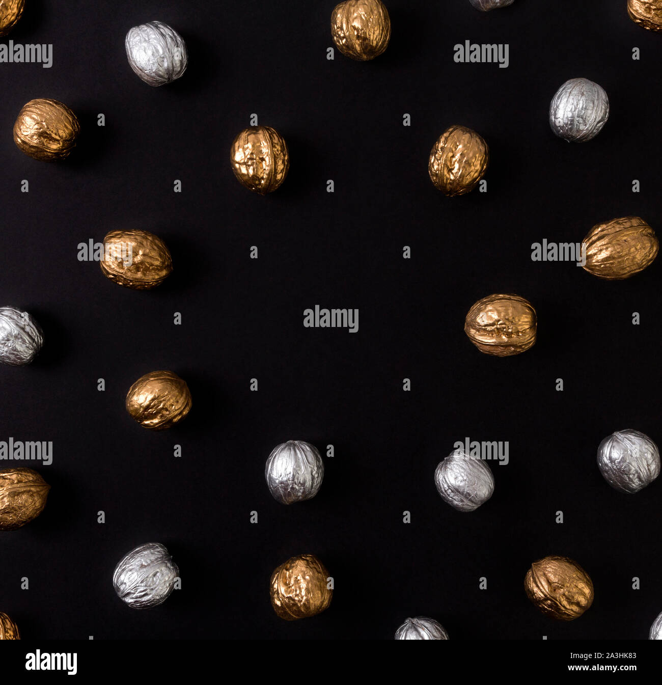Painted golden and silver walnuts on black background Stock Photo