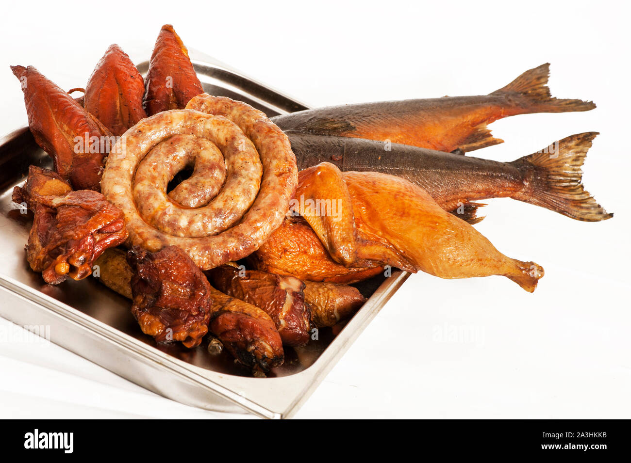 Smoked meat, sausages, fish, poultry on a white background Stock Photo