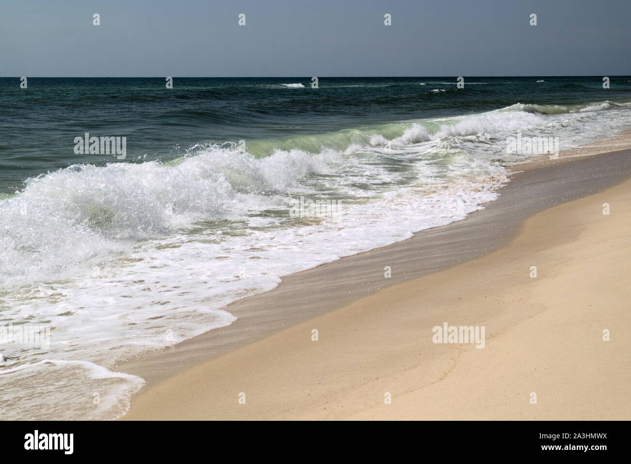 Waves rolling in on the beach at the Rosamond Johnson, Jr. National Park near Pensacola, Florida. Stock Photo
