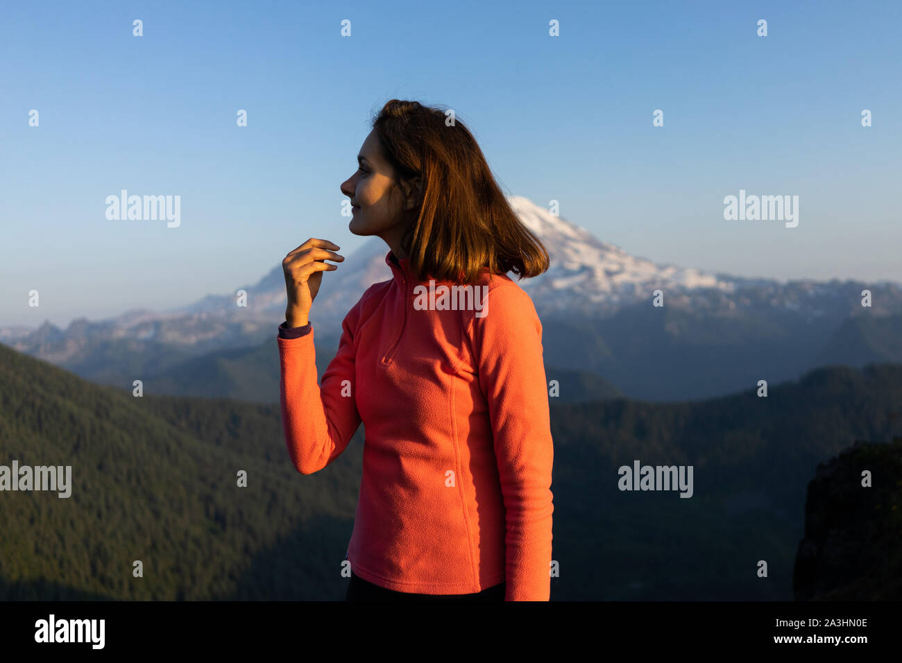 Woman hiker is loving the sunset at mount Rainier National Park, Wash Stock Photo
